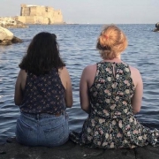 Two women sitting on a dock